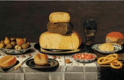 A breakfast with cheese, bread, fruit and roemer, on a partially draped table